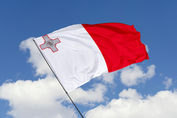 Fototapeta na wymiar Malta flag isolated on the blue sky background. close up waving flag of Malta. flag symbols of Malta. Concept of Malta.
