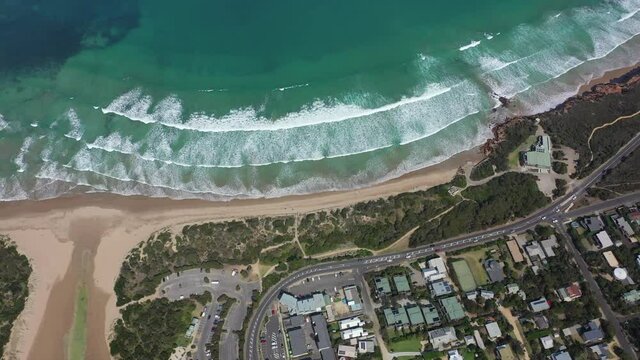 Vertical aerial tilts from Anglesea to shallow ocean bay in Australia