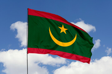 Mauritania flag isolated on the blue sky background. close up waving flag of Mauritania. flag symbols of Mauritania. Concept of Mauritania.