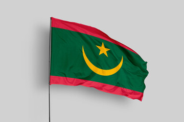 Mauritania flag isolated on the blue sky background. close up waving flag of Mauritania. flag symbols of Mauritania. Concept of Mauritania.