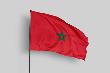 Morocco flag isolated on the blue sky background. close up waving flag of Morocco. flag symbols of Morocco. Concept of Morocco.