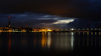 Fototapeta na wymiar Autumn sunrise in Riga reflection of night lights in the Daugava