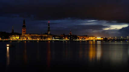 Fototapeta premium Autumn sunrise in Riga reflection of night lights in the Daugava