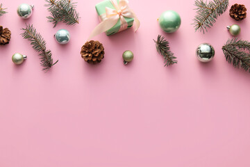 Christmas decorations, fir branches and cones on color background