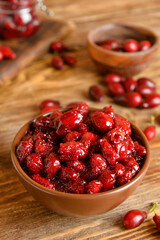 Bowl of sweet dogwood jam on wooden background