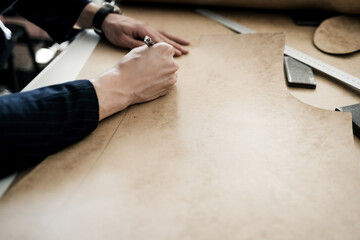 the tailor is working with a drawing