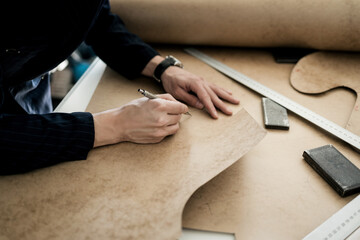 tailor working with sewing pattern