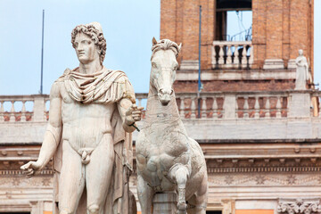 Statue of Pollux at the Cordonata stairs in Rome Italy . Naked statue of Roman mythology . Sculpture of man with horse