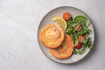 Salmon Pinwheel stuffed with cheese with salad