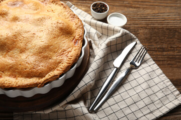 Baking dish with tasty chicken pot pie on wooden background, closeup
