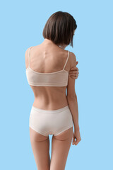 Young skinny woman on color background. Anorexia concept