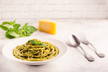 Pasta spaghetti with pesto sauce and fresh basil leaves