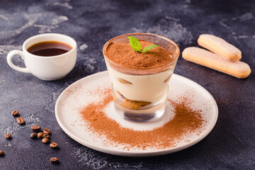 Traditional Italian dessert tiramisu in a glass.