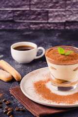 Traditional Italian dessert tiramisu in a glass.