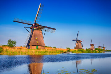 Naklejka premium Romantic Dutch Windmills in Kinderdijk Village in the Netherlands Before Sunset.