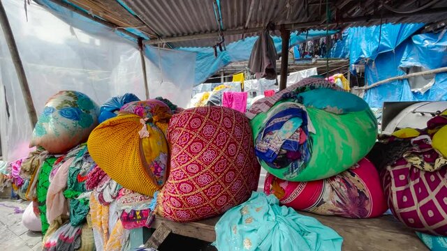Bundles Of Clothes Wrapped In Fabric Sheets In An Open-Air Laundry Place. Dhobi Ghat In Mumbai, India. orbiting