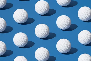 Wandcirkels aluminium Arranged white golf ball on blue pastel background. Minimal design. © Lazarevic Photoworks