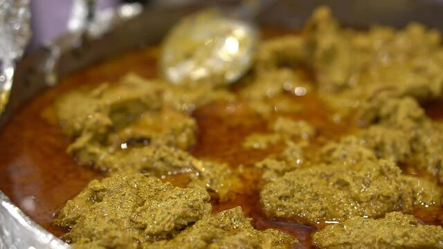 Cinematic shot of Chicken Rezala, Popular Eastern Indian Cashew Chicken with Gravy Top Down Photo with Assorted Spices on White Background