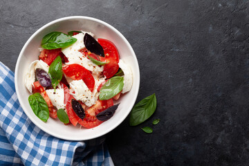 Caprese salad with fresh tomatoes, garden basil and mozzarella cheese