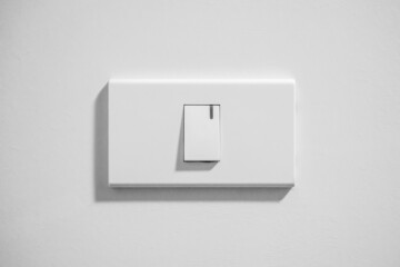 white lighting switch on concrete wall background