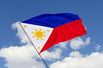 Philippines flag isolated on the blue sky background. close up waving flag of Philippines. flag...