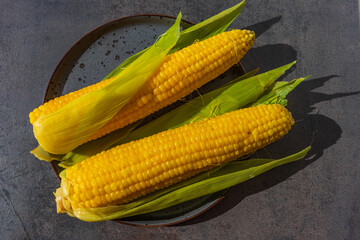 Yellow boiled corn on the cob on a plate