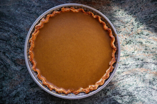 Pumpkin Pie From Above On The Kitchen Counter. Top Down Festive Cake Indoors.