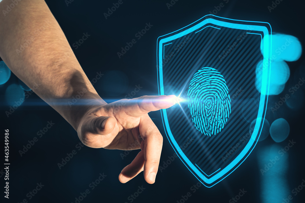 Poster close up of male hand pointing at creative glowing blue finger print and shield interface on blurry 