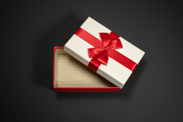 Wrapped vintage gift boxes with red ribbon bow, isolated on black