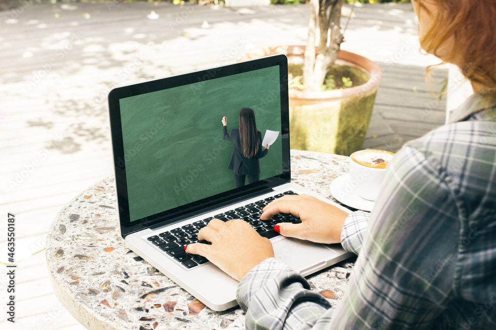 Aufkleber close up of young casual girl hands using laptop keyboard at wooden cafe table with coffee cup and o