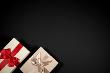 Wrapped vintage gift boxes with red ribbon bow, isolated on black