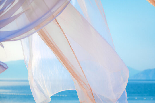 White pergola curtains at seaside