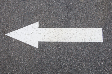 white arrow on a gray background. driving direction concept. road sign on dark background
