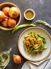 green string beans stewed with mushrooms on a dark background with light textiles