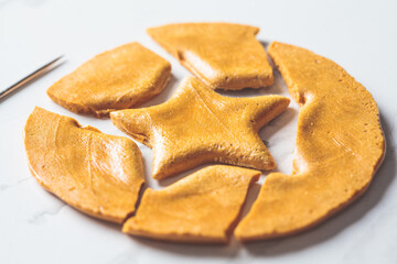 Dalgona Candy - South Korean treat. Round sugar cookie with star inside.