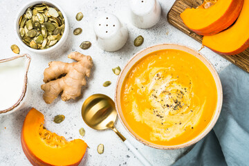 Pumpkin soup puree with cream and ginger in the bowl. Traditional autumn dish. Top view image at...