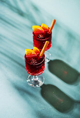 Hot mulled wine with fruits and spices, top view. Christmas and holidays festive background