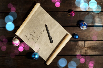 Christmas card on a wooden table with the inscription dear Santa.