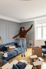 Cheerful woman celebrating relocating into a new apartment.