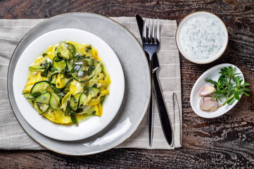 Fried zucchini with melted cheese, garlic and purslane