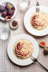 Risotto with figs, bacon and taleggio cheese. Vertical image.