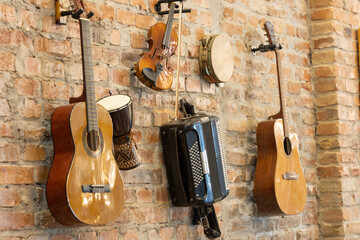 Old instruments hanging on the brick wall as a decoration