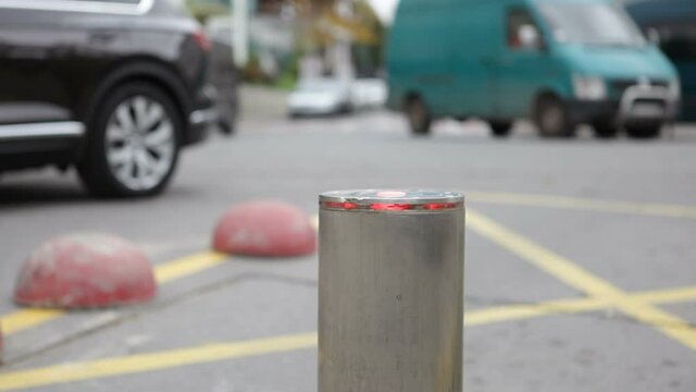 Retractable automatic bollard with LEDs near the pedestrian zone.