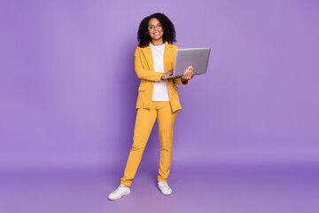 Photo of pretty adorable lady wear yellow suit glasses smiling holding modern gadget isolated...