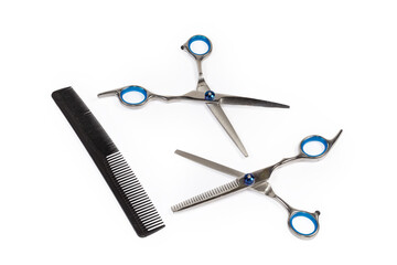 Two different professional stainless steel hair scissors and plastic comb