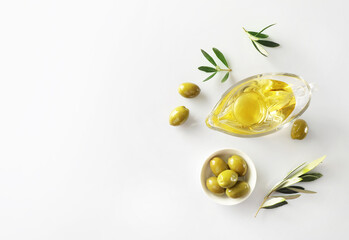 Olive branch and olive oil isolated on white background. Top view