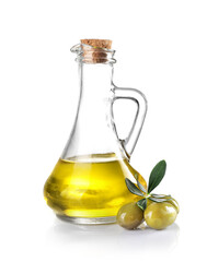 Green olives and olive oil pitcher isolated on white.