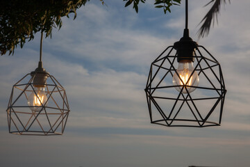Decorative filament bulb on a terrace at dusk