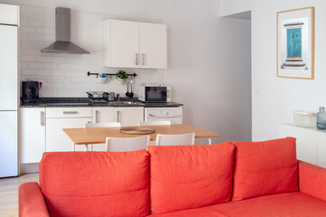 Interior spacious light dining room connected with kitchen in modern contemporary style