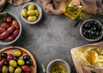 Virgin olive oil, olives and fresh bread on the table. Top view
